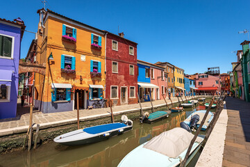 Fototapeta na wymiar Burano island in the Venetian lagoon with multi colored houses and small canal with moored boats. Venice, UNESCO world heritage site, Veneto, Italy, Europe.