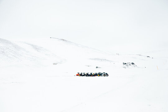 Snowmobiles on mountains on winter day