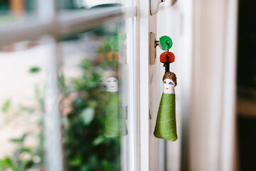 Soft fabric key chain with keys sticking out from keyhole of terrace door