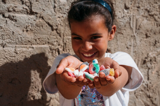 Black kid with handful of candies
