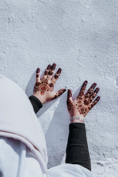 Crop ethic woman showing tattooed hands