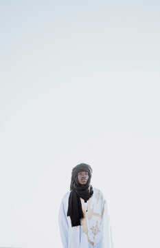 Black man in keffiyeh in desert