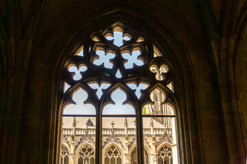 View of the cathedral of Utrecht through one arch in the herb garden of the monastery
