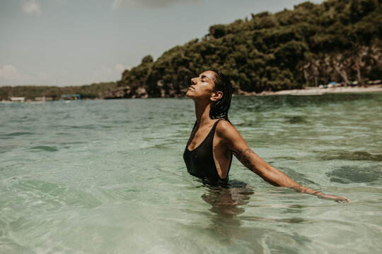 Woman relaxing in water at seaside