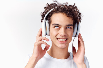 Fototapeta premium happy guy with headphones curly hair emotions close-up