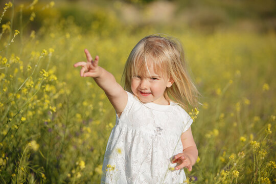 little beautiful girl in nature with flowers