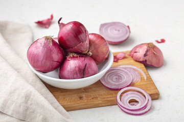 Shallot in white bowl on chopping board