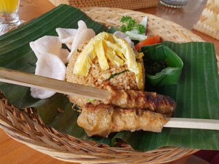 Indonesian food dish chicken satay with fried rice. Meal of Bali.