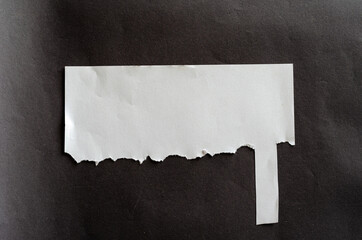 White blank sheet of paper with last tear off tab on gray background. Crumpled sheet. Last tear-off...