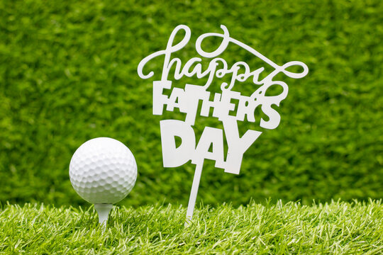 Golf Father's Day with golf ball and sign are on green grass