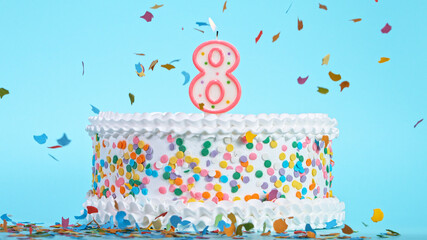 Colorful tasty birthday cake with candles shaped like the number 8. Pastel blue background.