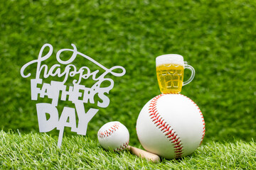 Baseball Father's Day with ball and sign are on green grass background