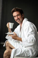 Young man drinking coffee in the morning at hotel, spa