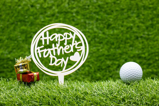 Golf Father's Day with golf ball and sign are on green grass background