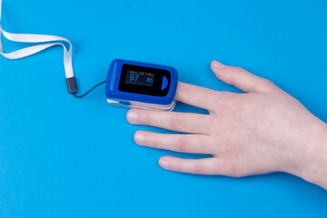 Pulse oximetry on the finger with blue background. Pulse oximetry a noninvasive and painless test that measures oxygen saturation level. Part of set.