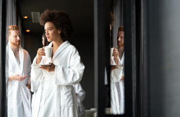 Close-up portrait of beautiful young woman drinking coffee in health spa
