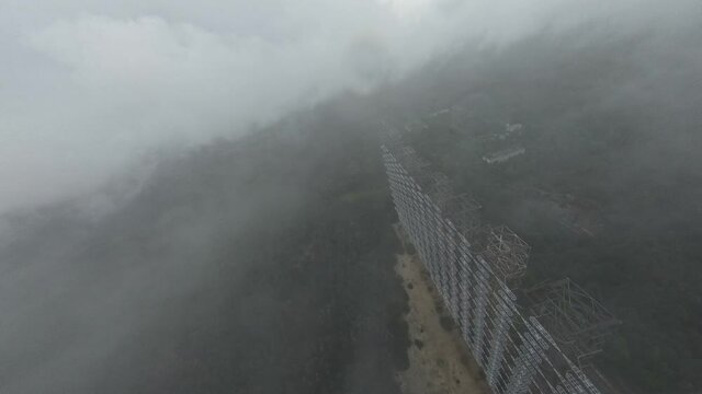 FPV drone view of over horizon duga radar system in the rain. The Chernobyl Exclusion Zone