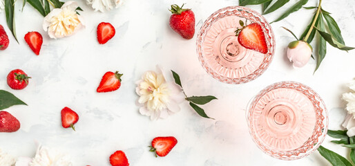 Glass Of White Wine, sweet fresh strawberries and Peony Flowers. Summer drink for party, wine shop or wine tasting concept
