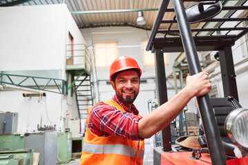 Warehouse worker is training to be a forklift driver