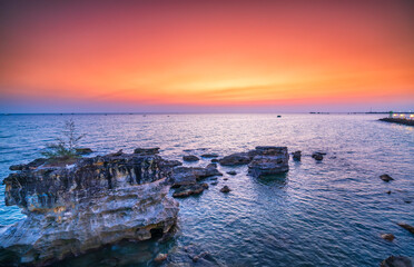 Sunset on the bay colorful sky, below is a large rock formation towards the horizon abstract create stunning scenery to admire nature