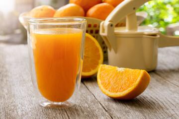 Orange juice and fresh organic oranges fruits on wood table background.