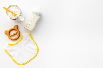 Baby milk in bottle with toy and powdered milk