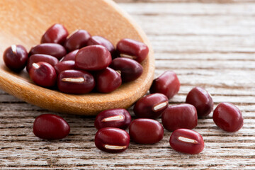 Red Azuki beans (Adzuki or japanese red bean) isolated on wood table background.