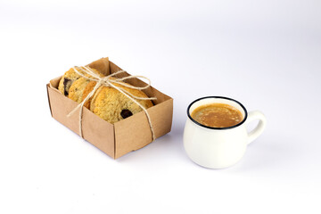 Hot black coffee with foam and sweet chocolate cookies in kraft paper box on white background. Part of set.