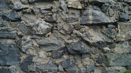 the wall is made of gray stones