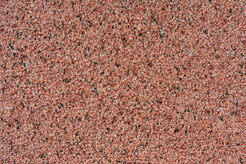 Pattern texture of rough surface red granite. Macro photo, close up view.