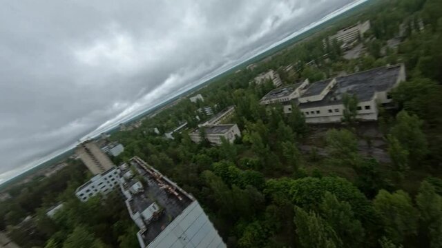 FPV drone view. Flight over central square of abandoned Pripyat city in the rain.