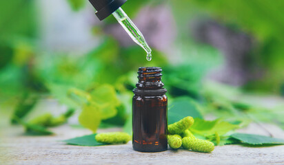 Birch bud extract in a small bottle. Selective focus.
