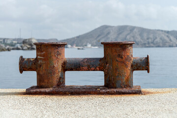 Knechts on pier against backdrop of sea and mountains.