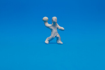 A white modeling clay dummy practicing handball