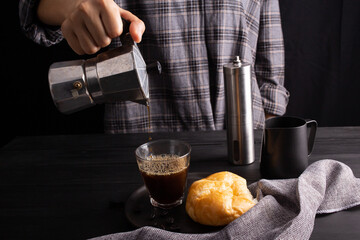 The professional of a barista poured coffee. making milk coffee with equipment, tool brewing on the bar at kitchen home