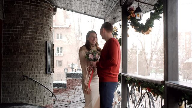 Guess who romantic rendevous concept. Romantic woman meeting man on Christmas date. Man waiting beloved woman with bouquet of flowers