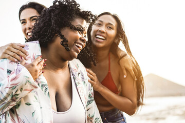 Happy multiracial women with different bodies and skins having fun in summer day on the beach - Focus on african girl face