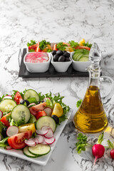 Vegetable salad and Olive oil in a bottle. Fresh chopped vegetables in a salad bowl. Healthy eating. Vegetarian food. Healthy nutrition concept. High quality photo