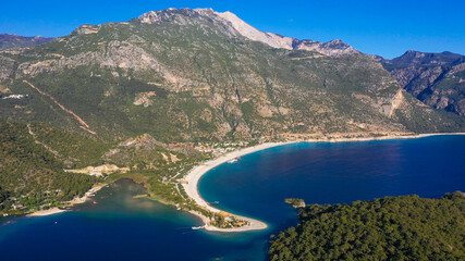 Fototapeta premium Ölüdeniz is a small neighbourhood and beach resort in the Fethiye district of Muğla Province, on the Turquoise Coast of southwestern Turkey, at the conjunction point of the Aegean and Mediterranean se