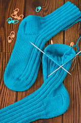 Knitting a warm sock from blue wool yarn