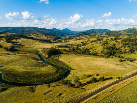 Bendy river winding through valley towards lake