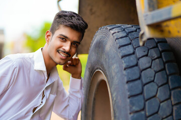 Fototapeta na wymiar Young indian businessman with his freight forward lorry or truck.