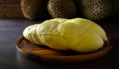 Durian Thai fruit, put in old wooden tray on wooden table and old wooden wall