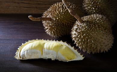 Durian and durian pulp, Thai fruit put on old wooden table and old wooden wall