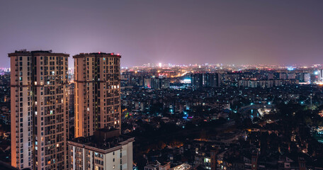 Long exposure night view on tall skyscrapers residential district buildings, city background. Beautiful night view cityscape of Chinese metropolis Chengdu.