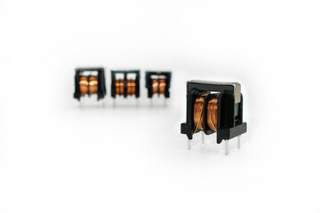 Ferrite core inductors. One is on foreground, other ones are on blurred background