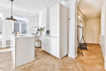 Modern galley kitchen with wooden cabinets and minimalist design in studio attic apartment with...