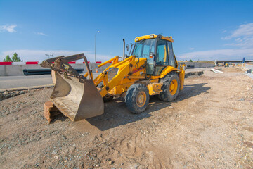 Paving the ground at road construction works with a bulldozer