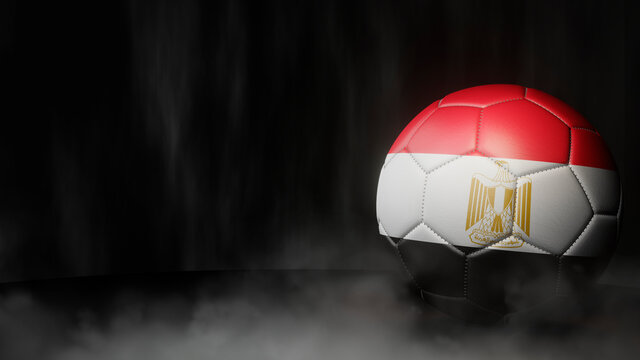 Soccer ball in flag colors on a dark abstract background. Egypt. 3D image.