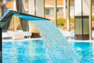 Wellness. Equipment in the indoor pool for back and neck massage. Cascading jet of high-pressure...